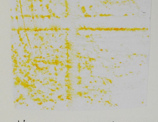 Yellow crayon on breeze block wall